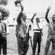 Kenya’s independence leader Jomo Kenyatta, second left, acknowledges cheers from followers at his home at Gatundu, near Nairobi (Aug. 21, 1961).